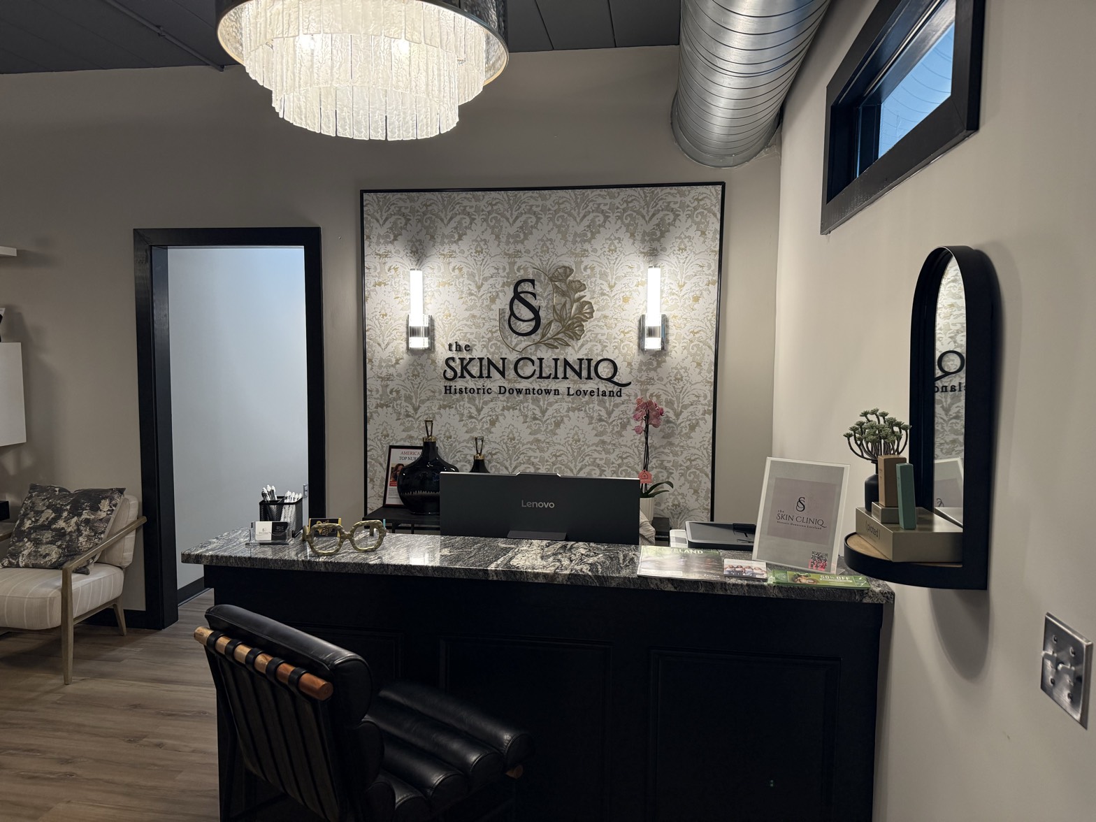 The Skin Cliniq reception and logo wall in Historic Downtown Loveland