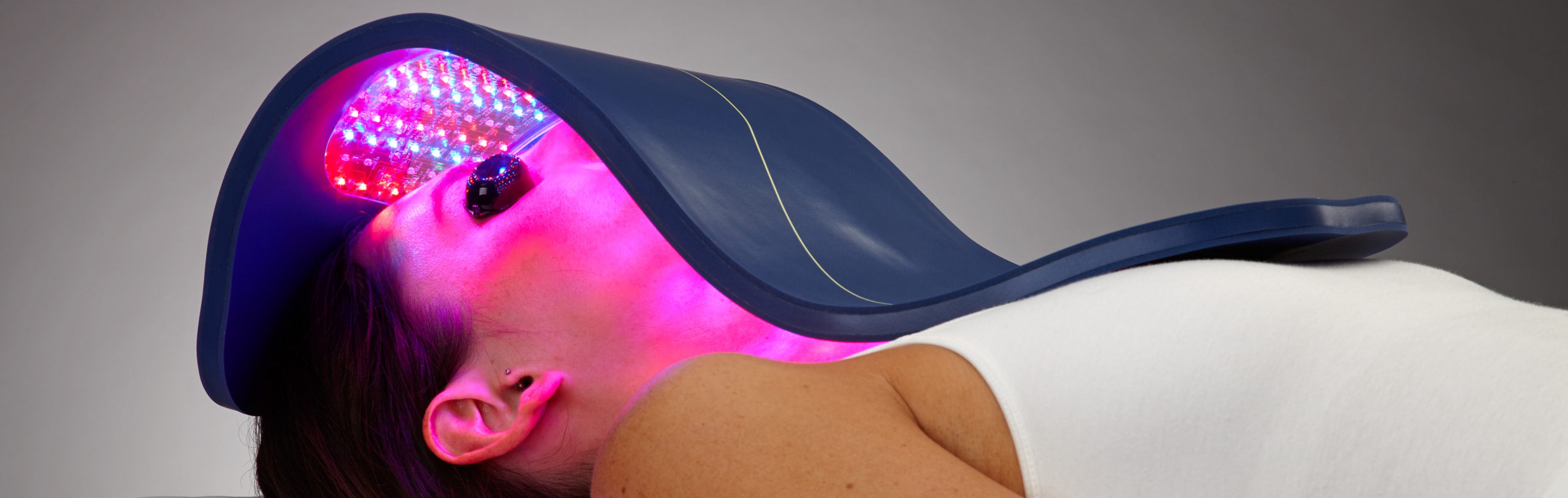 Celluma LED light therapy treatment — flexible panel over client's face